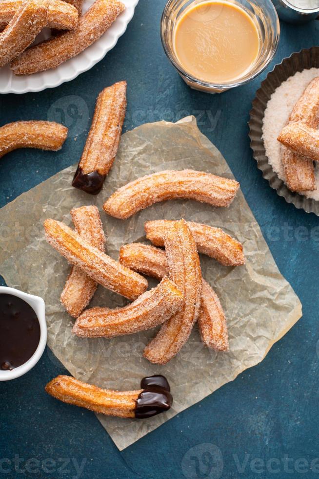 Homemade churros with cinnamon sugar on parchment photo