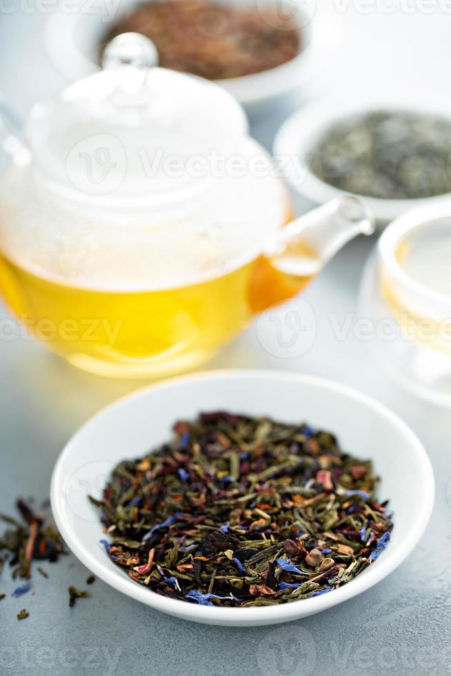 Green loose leaf tea and a teapot 15945618 Stock Photo at Vecteezy
