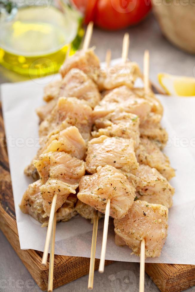 Chicken kebabs raw on a parchment paper photo