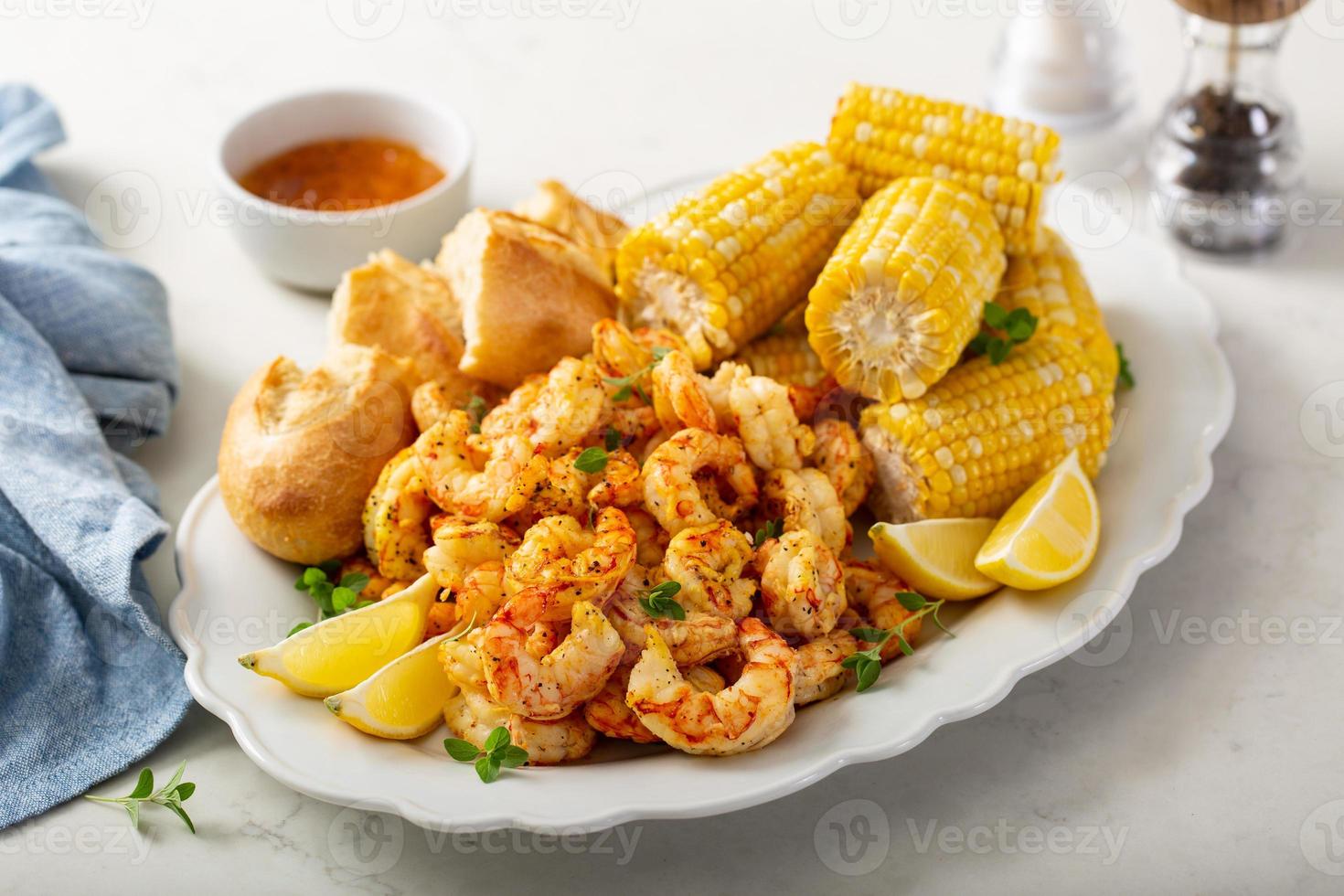 Fried shrimp and corn on the cob photo
