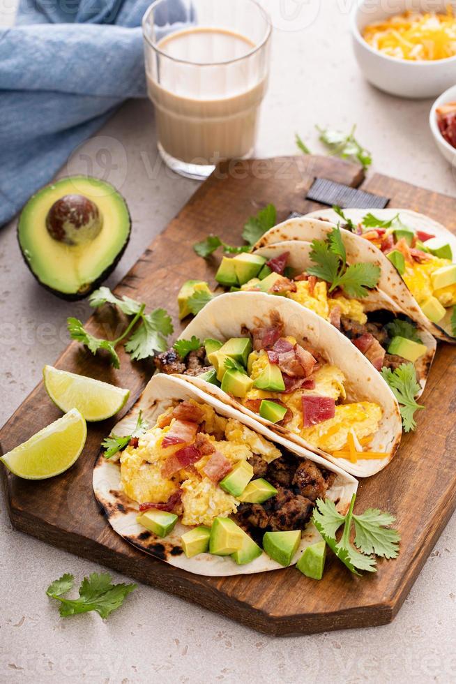 Breakfast tacos with sausage, eggs, bacon and avocado photo