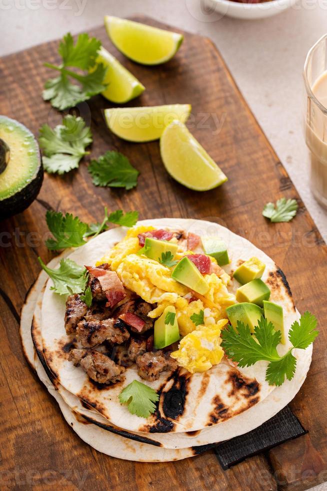 Breakfast tacos with sausage, eggs, bacon and avocado photo