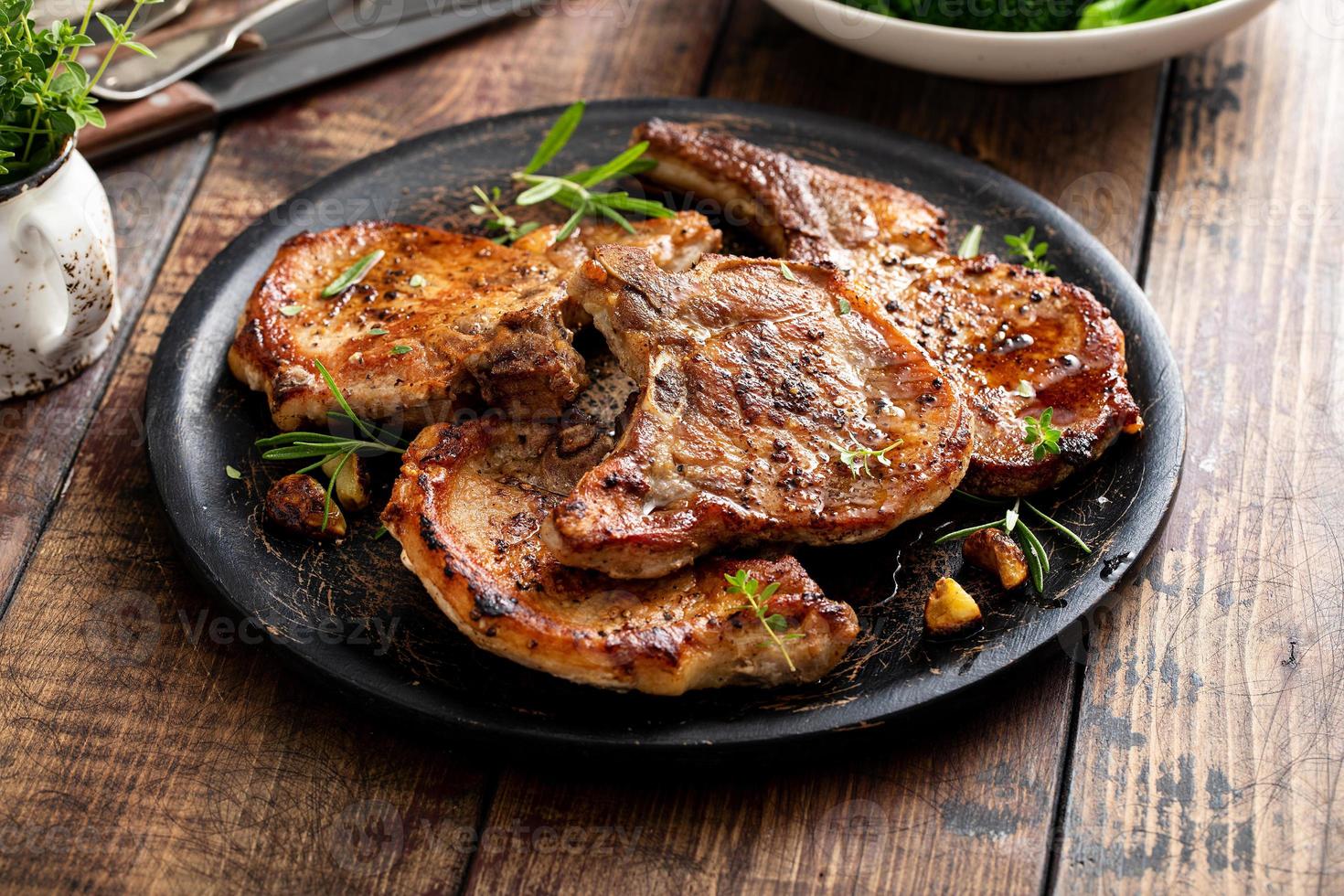 Grilled or pan fried pork chops on the bone photo