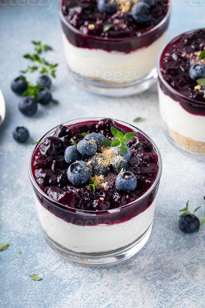 Blueberry cheesecake in a jar with graham cracker base photo
