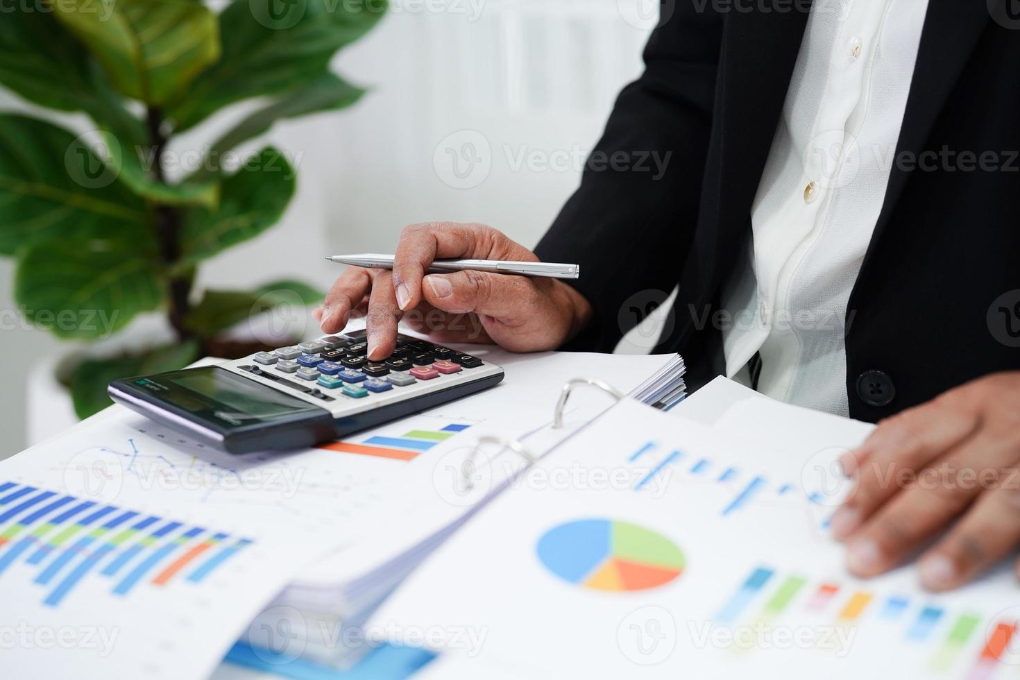 Business woman working and analysis with statistic graph in office. photo