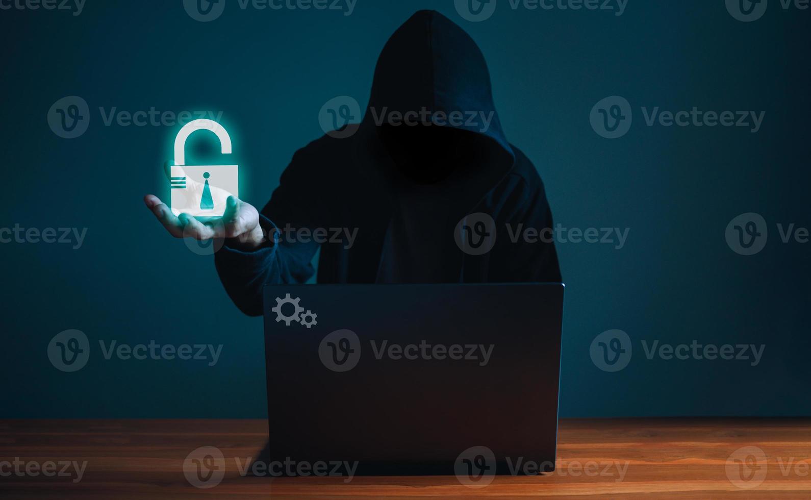 Hackers work on laptops in the dark. The concept of information security in the Internet network and information espionage. photo