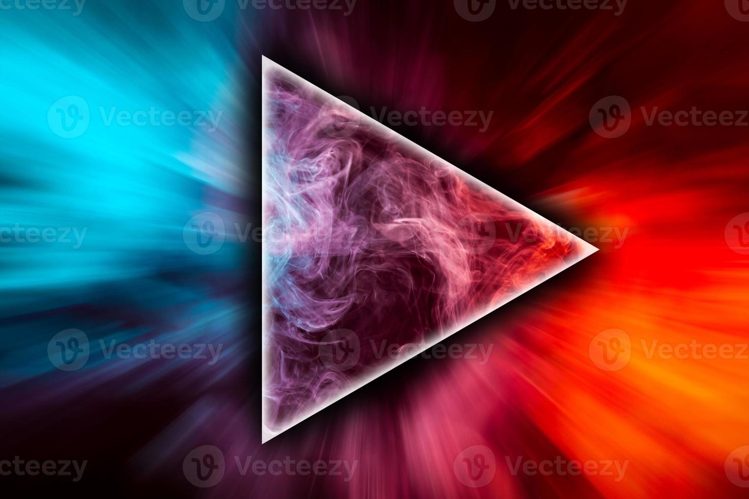 Fog colored with bright gel in the shape of a triangle on dark background photo