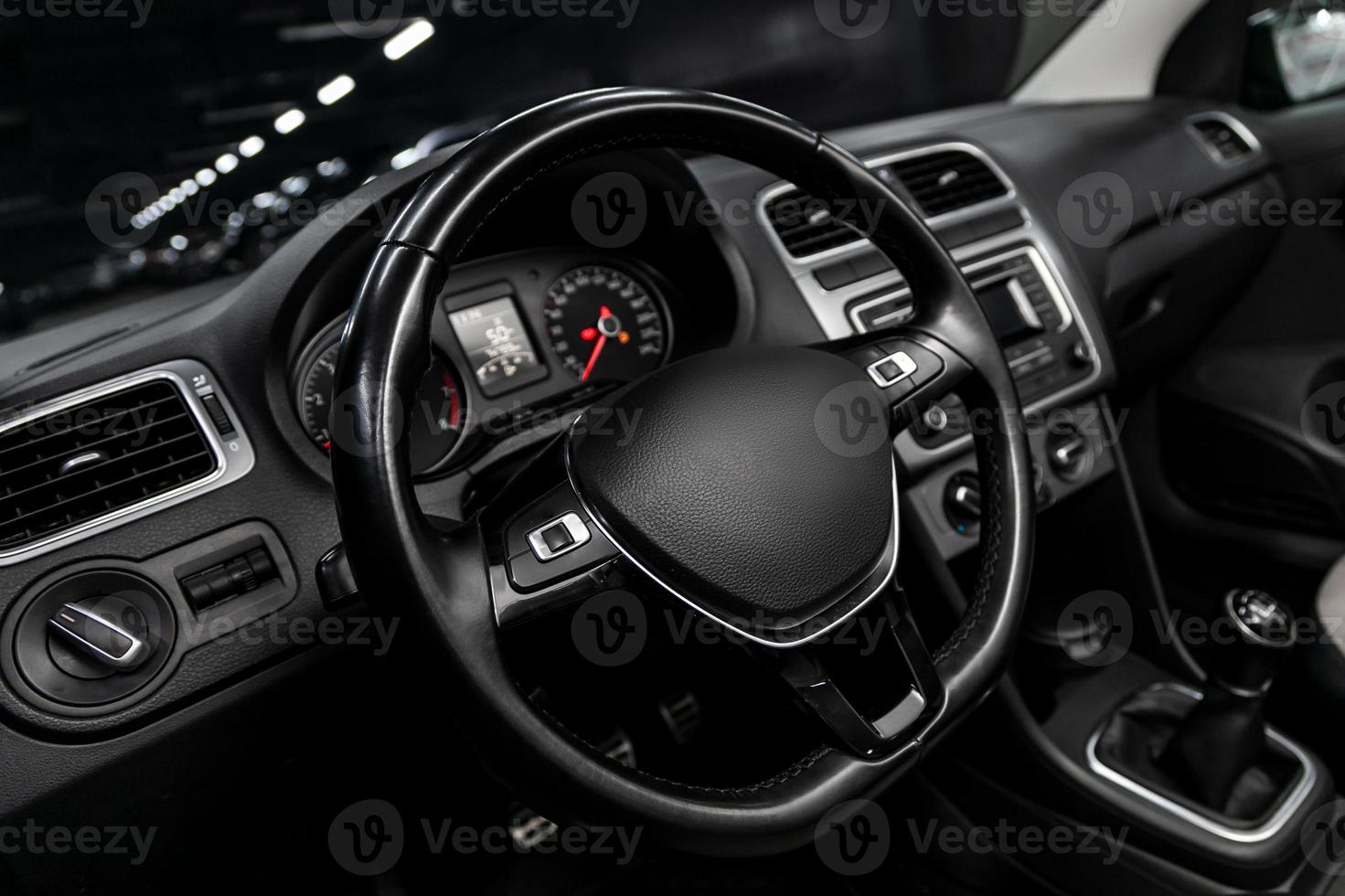 dashboard, speedometer, tachometer  with white backlight  steering wheel  with car controller system function. photo
