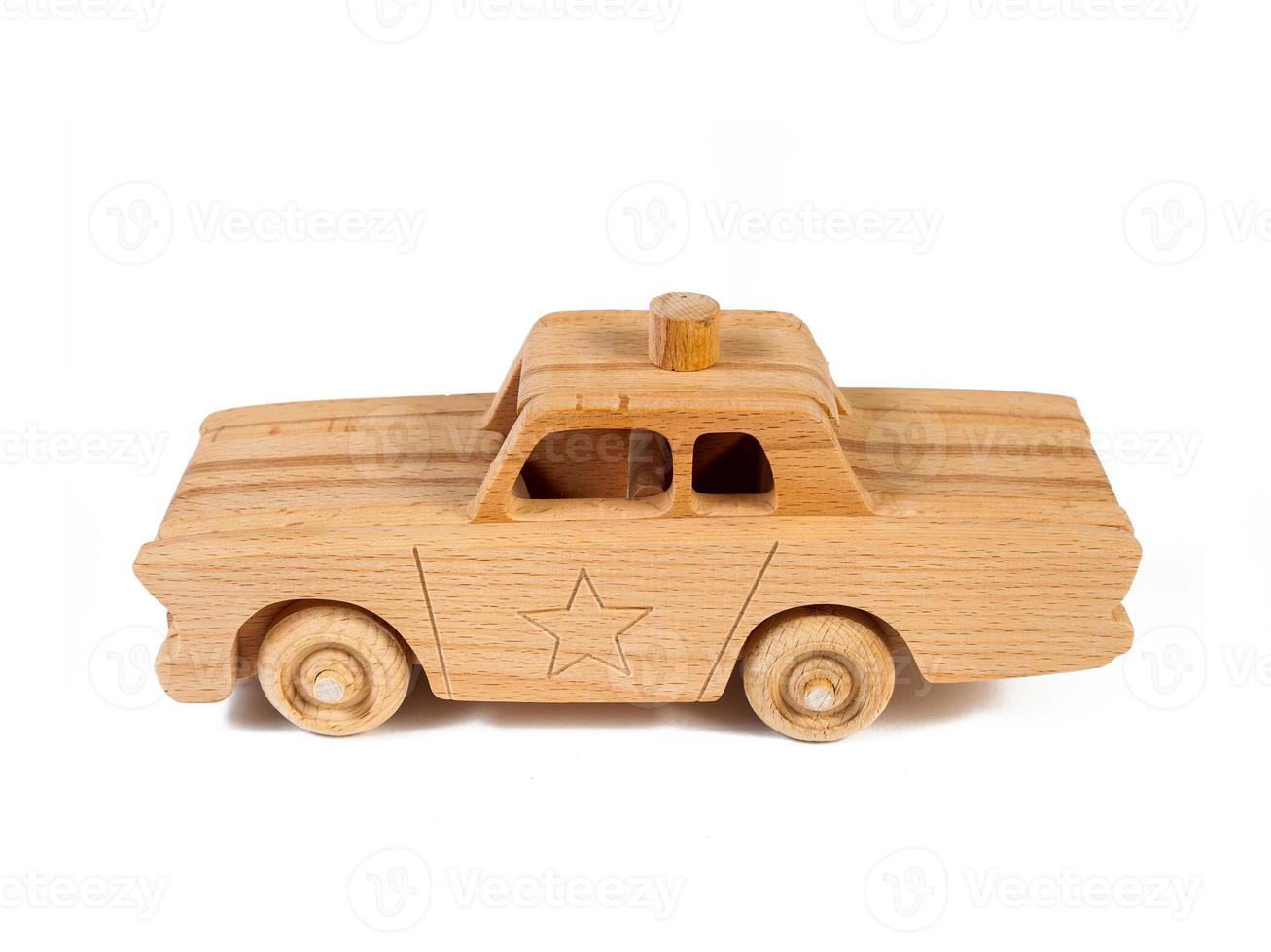 Photo of a wooden  police car  of beech. Toy made of wood retro car on a white isolated background