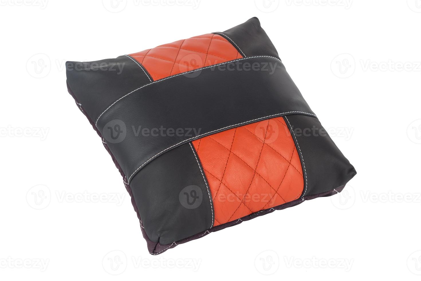 small handmade pillow with white stitching from genuine leather on a white isolated background, side view. photo