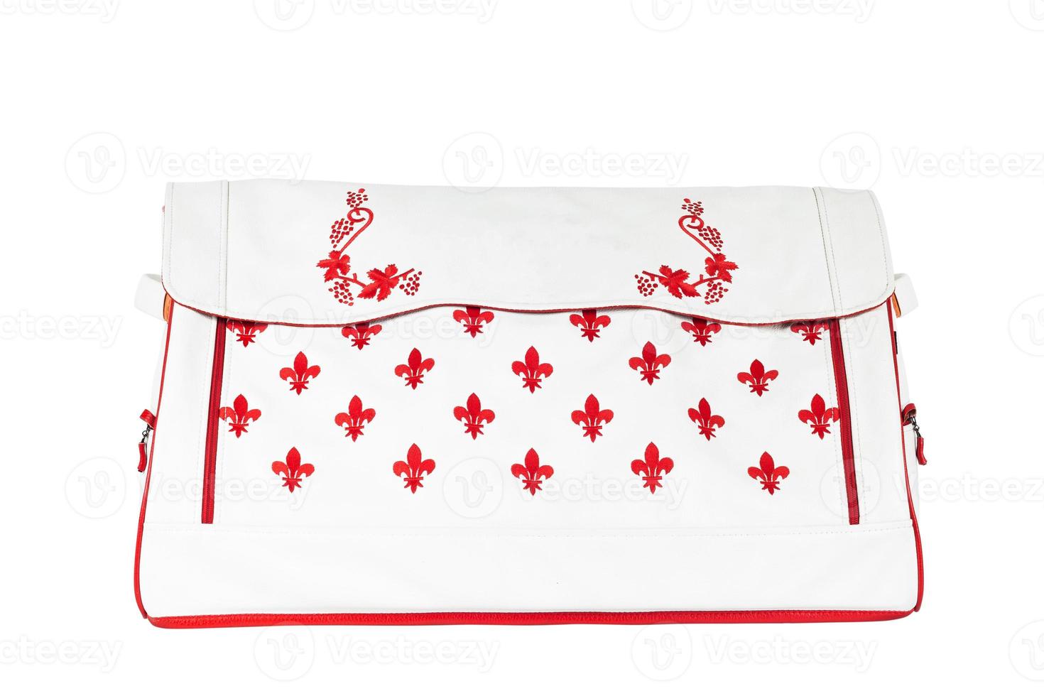 leather bag with red print for storing things and traveling in the trunk of a car on a white isolated background. Luggage, handmade suitcase photo