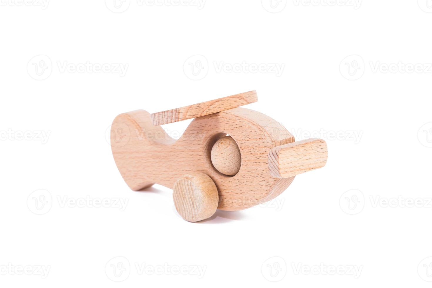 Toy made of wood retro aircraft on a white isolated background photo