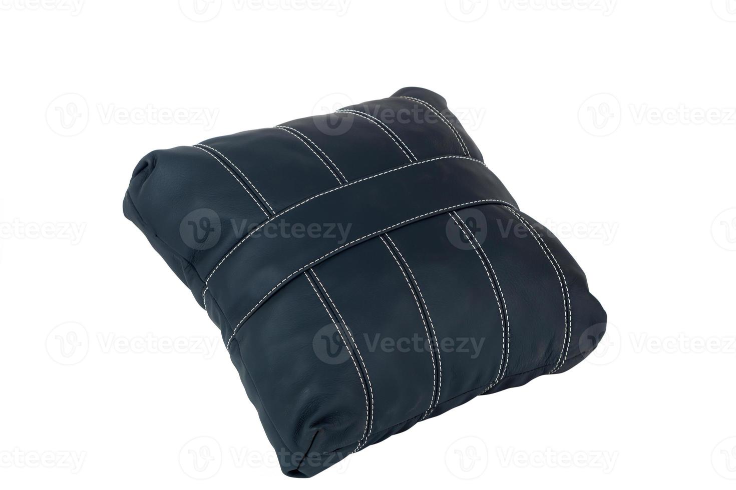 Black small handmade pillow with white stitching from genuine leather on a white isolated background, side view. photo