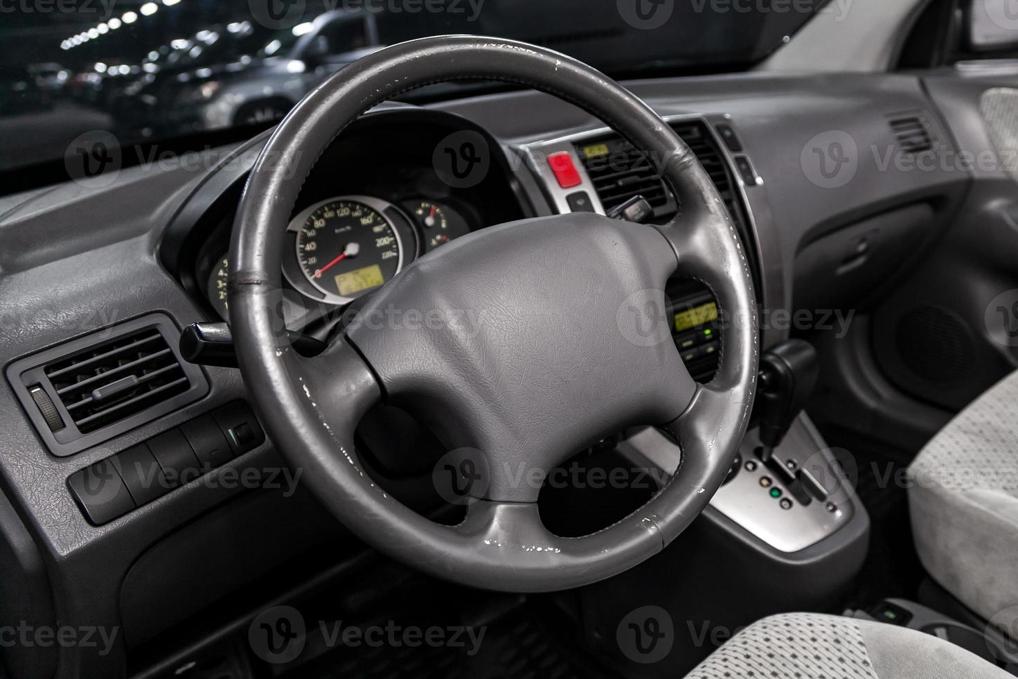 dashboard, speedometer, tachometer  with white backlight  steering wheel  with car controller system function. photo