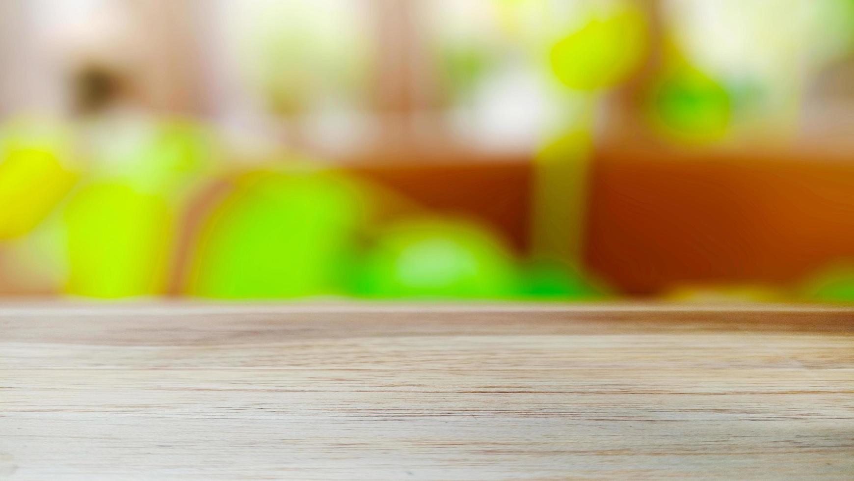 A wooden table with a blurry natural plant background with a fresh atmosphere photo