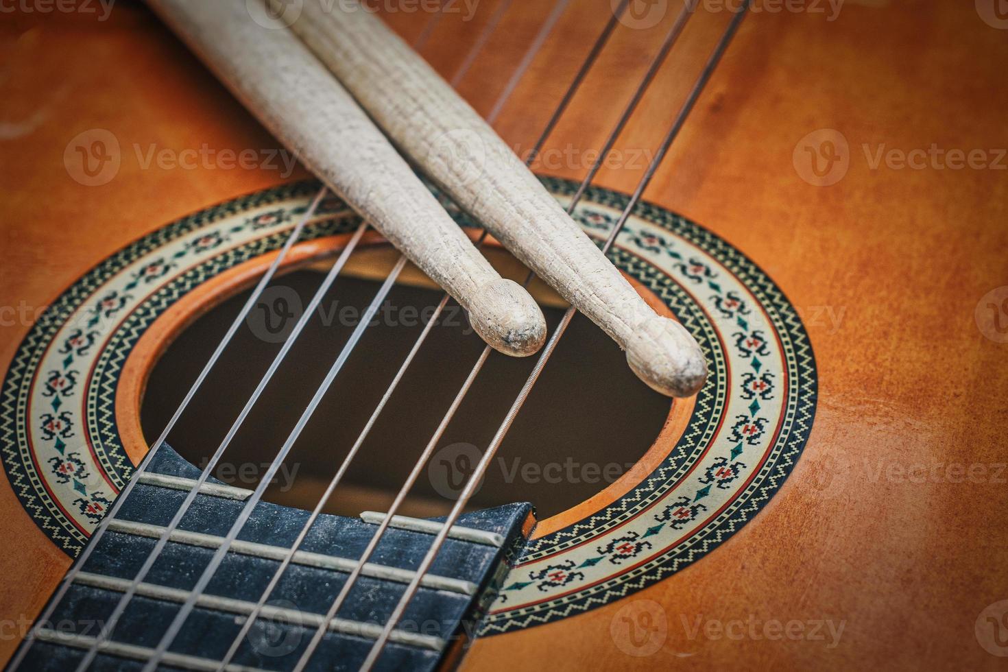 Drum sticks on guitar strings photo