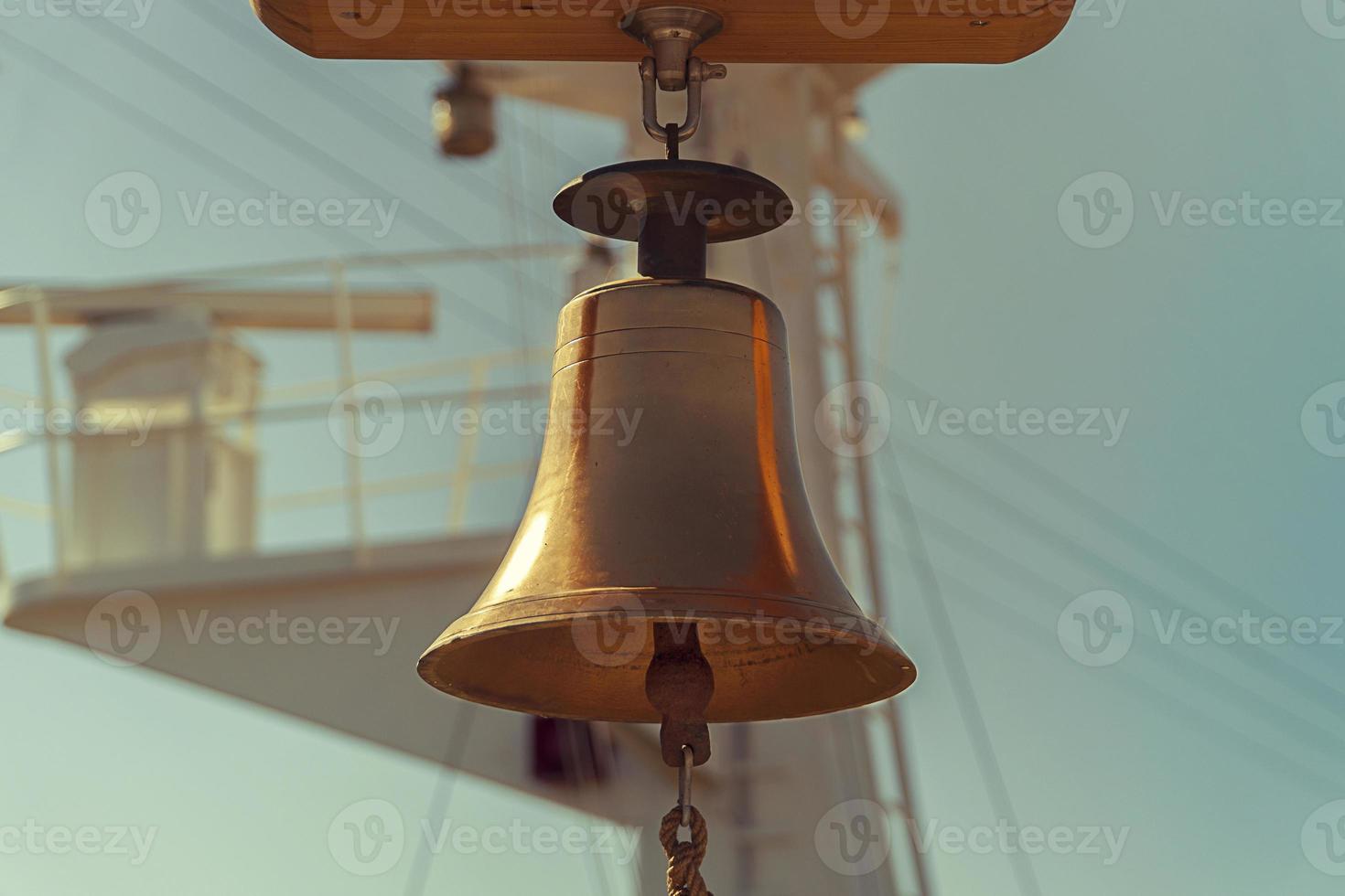A Sailing Ship's Bell and blue sky photo