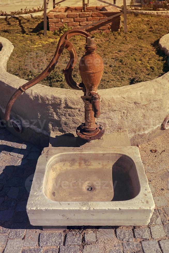 Old vintage antique water pump photo