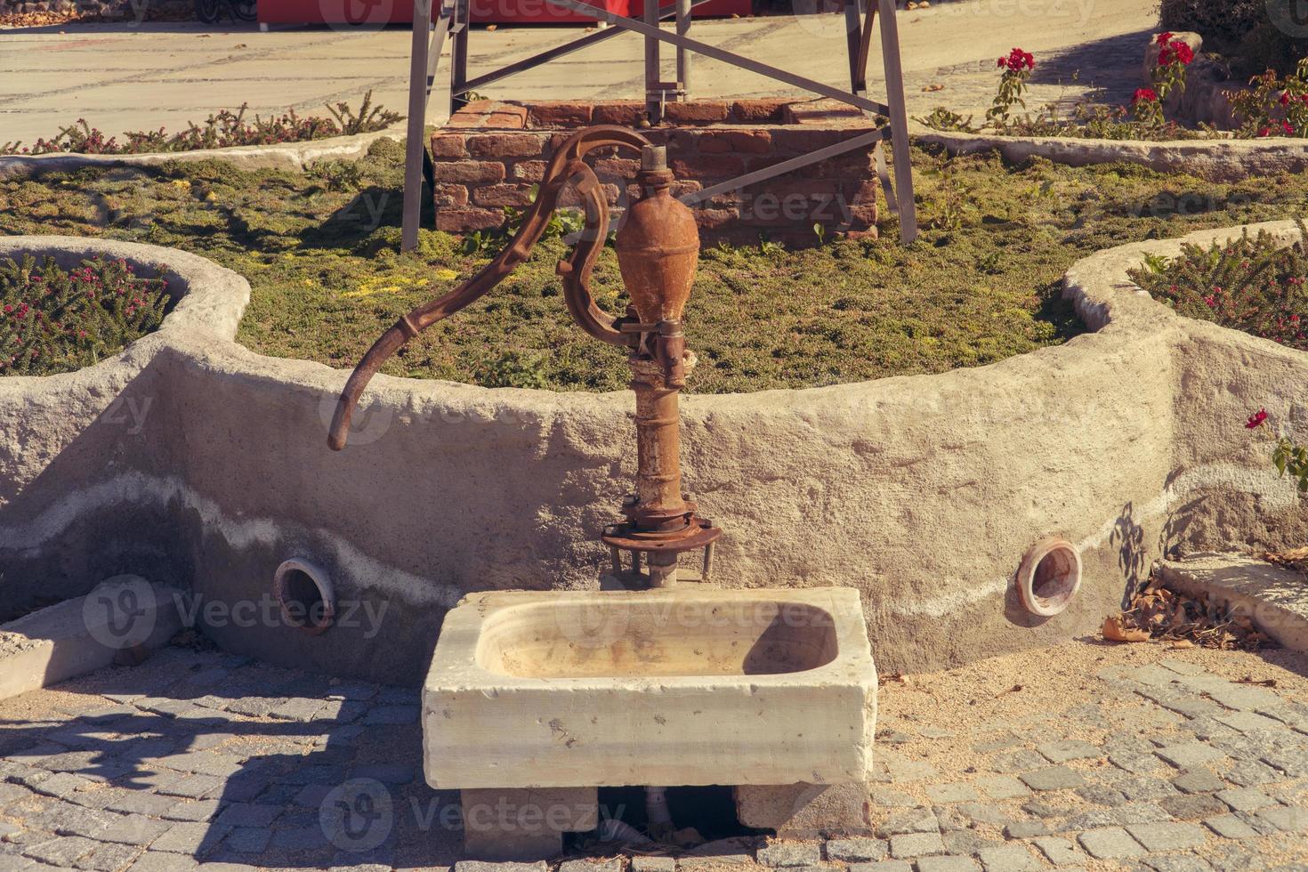 Old vintage antique water pump photo