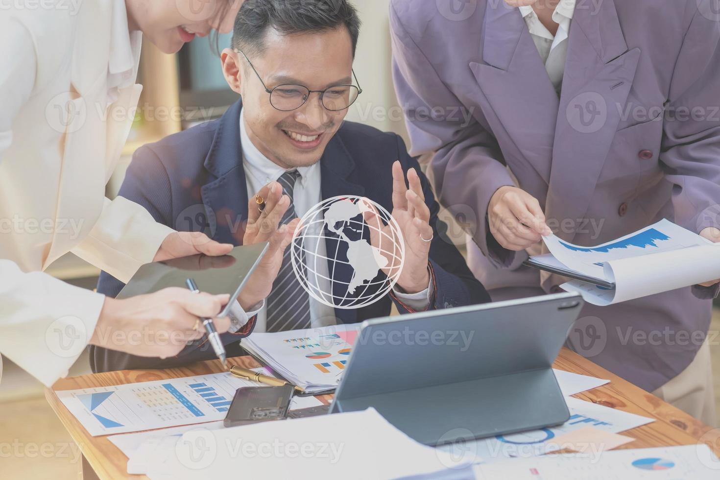 Asian business team consists of marketing staff. accountant and financial officer Help each other analyze company profits using tablets. calculator Laptop computers, graph paper, and corporate pens. photo