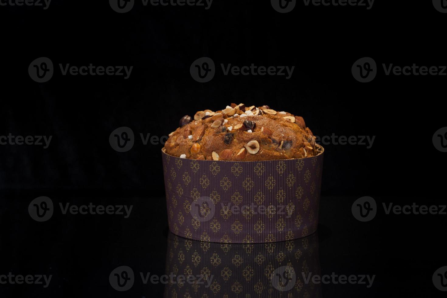 Panettone cake on a black background. It is the traditional Italian dessert for Christmas. Close up photo