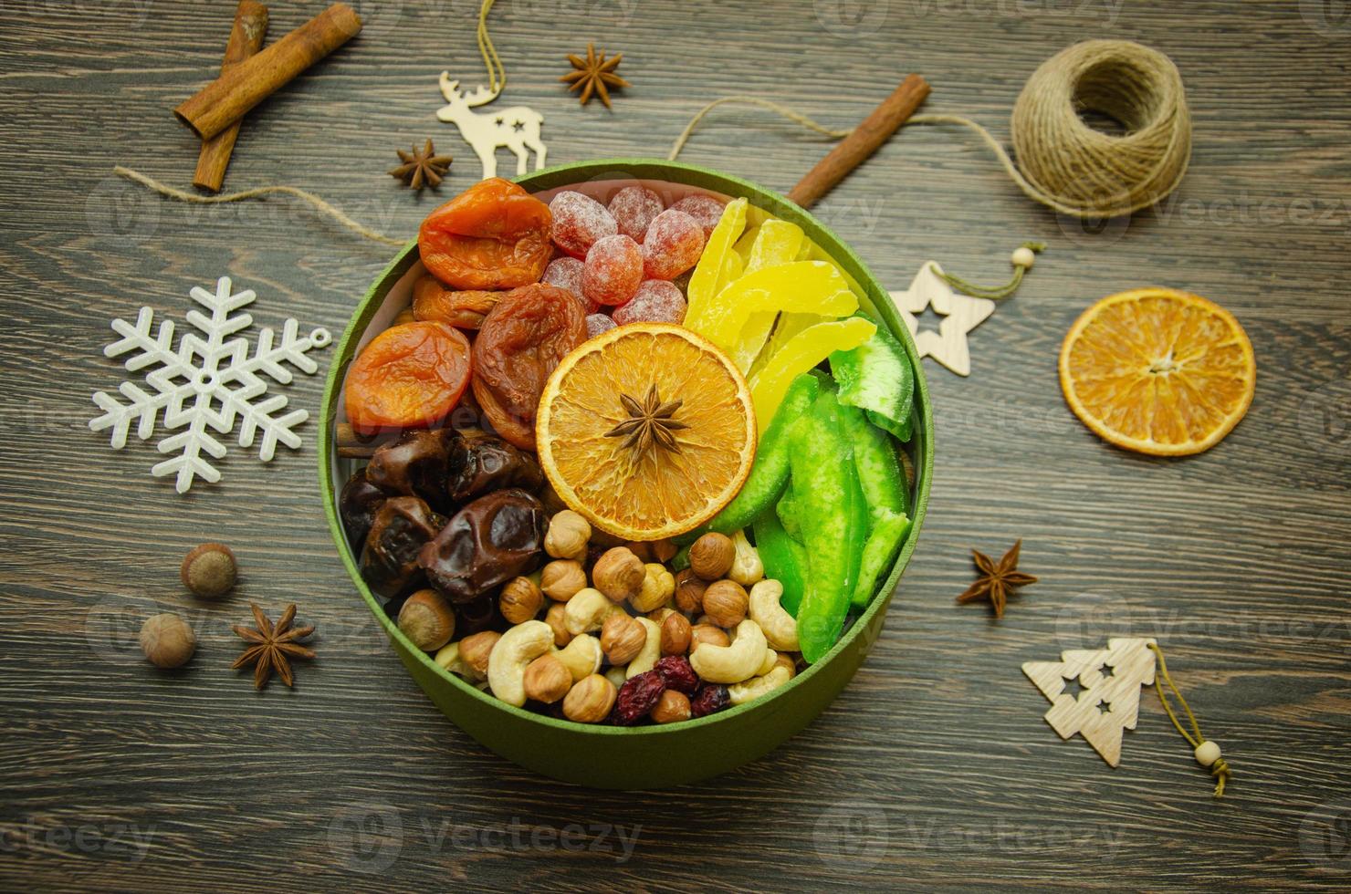 assorted dried fruit nuts and candied fruit in a box, top view photo