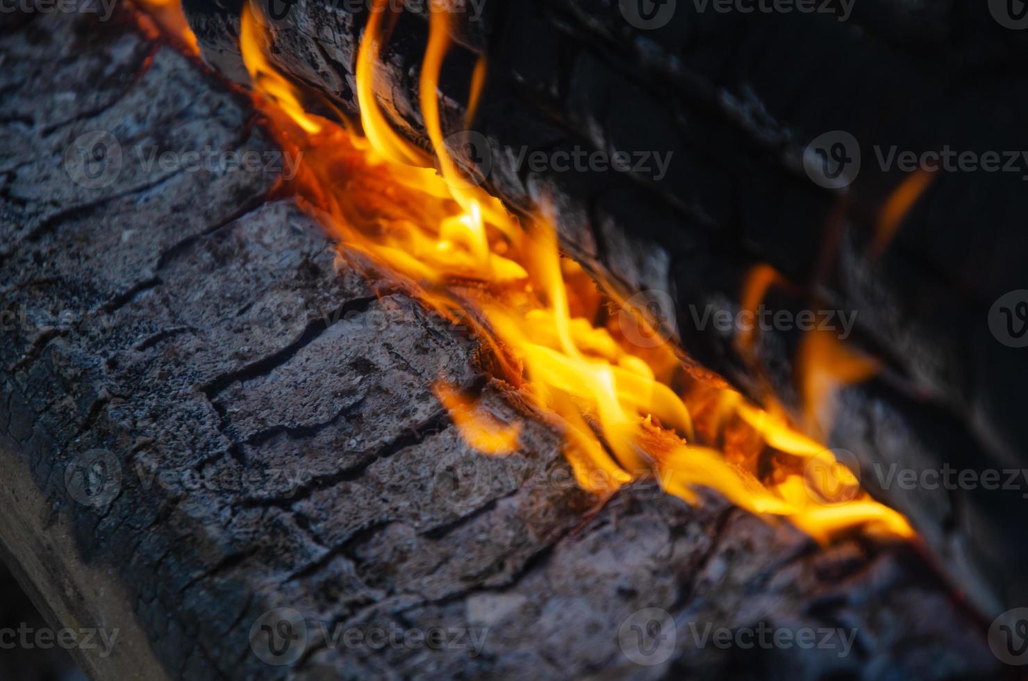 a long and weakly burning, smoldering fire made of logs. photo