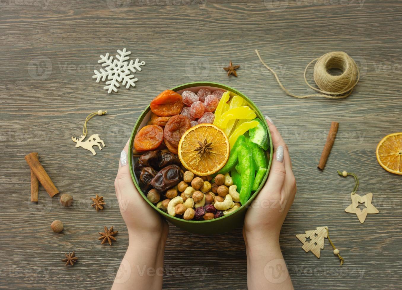 assorted dried fruit nuts and candied fruit in a box, top view photo