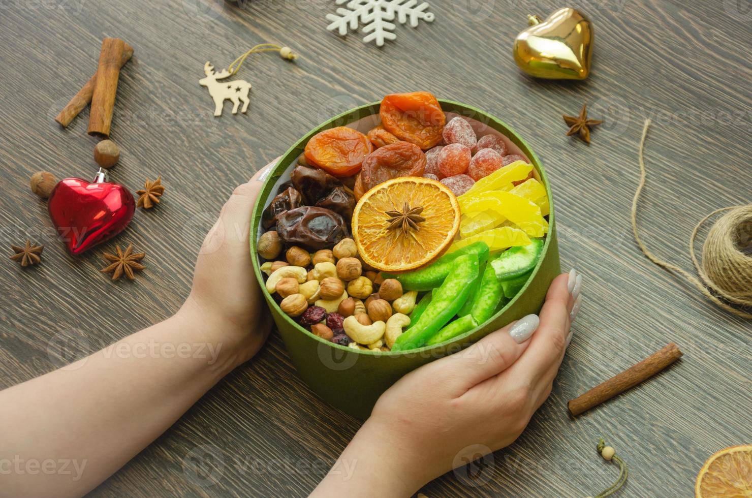 assorted dried fruit nuts and candied fruit in a box, top view photo