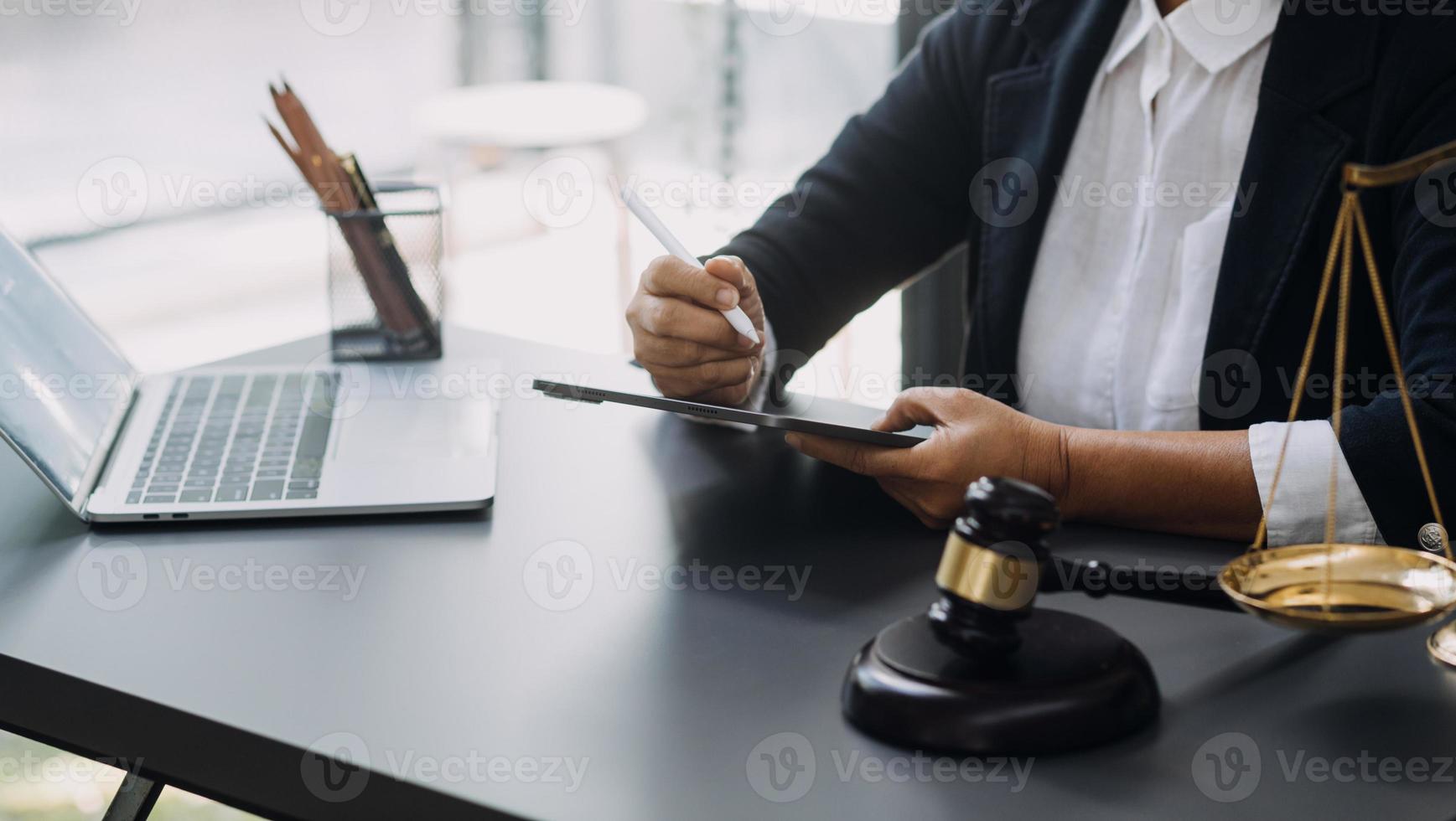 Business and lawyers discussing contract papers with brass scale on desk in office. Law, legal services, advice, justice and law concept picture with film grain effect photo