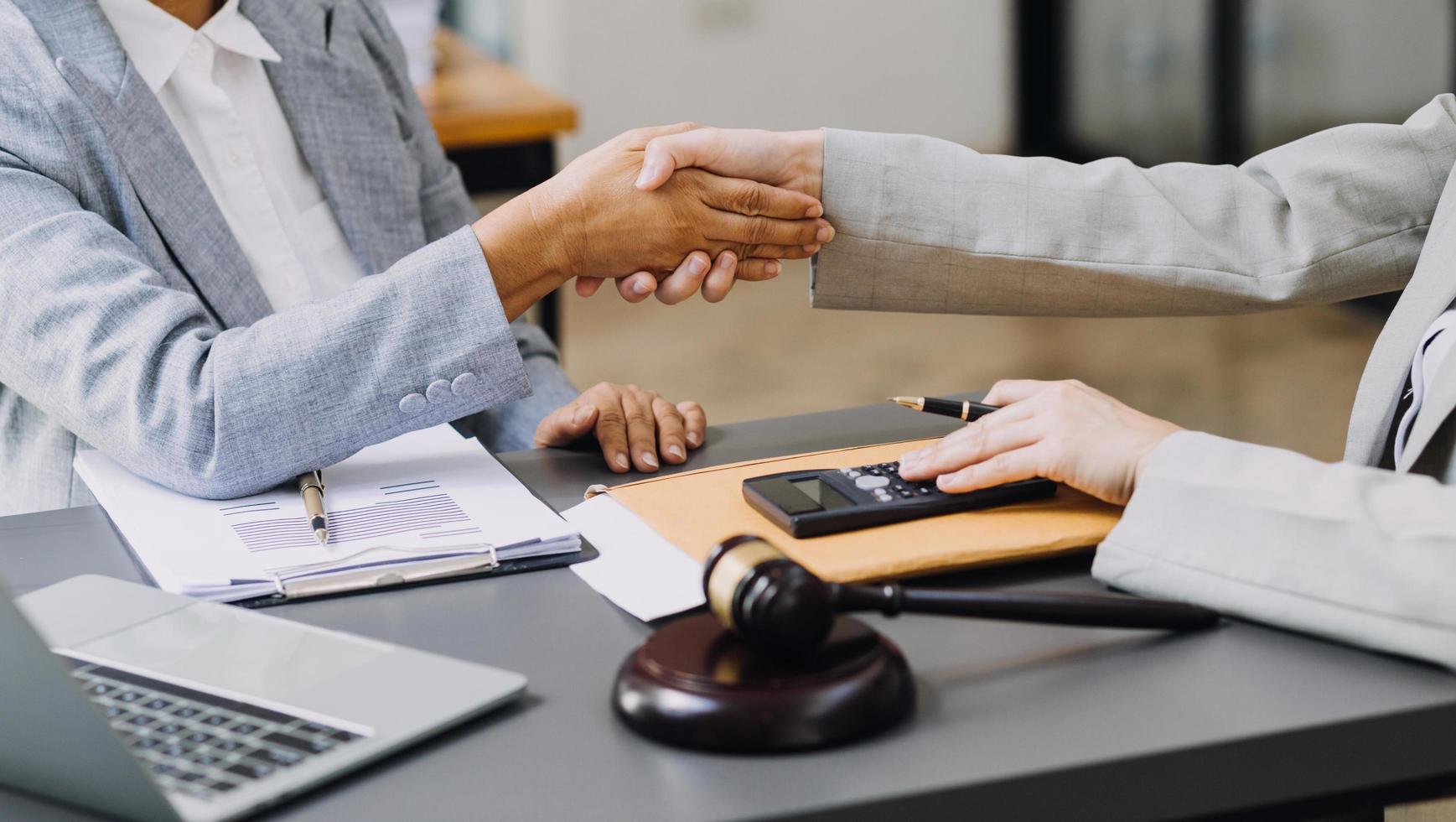 justice and law concept.Male judge in a courtroom on wooden table and Counselor or Male lawyer working in office. Legal law, advice and justice concept. photo