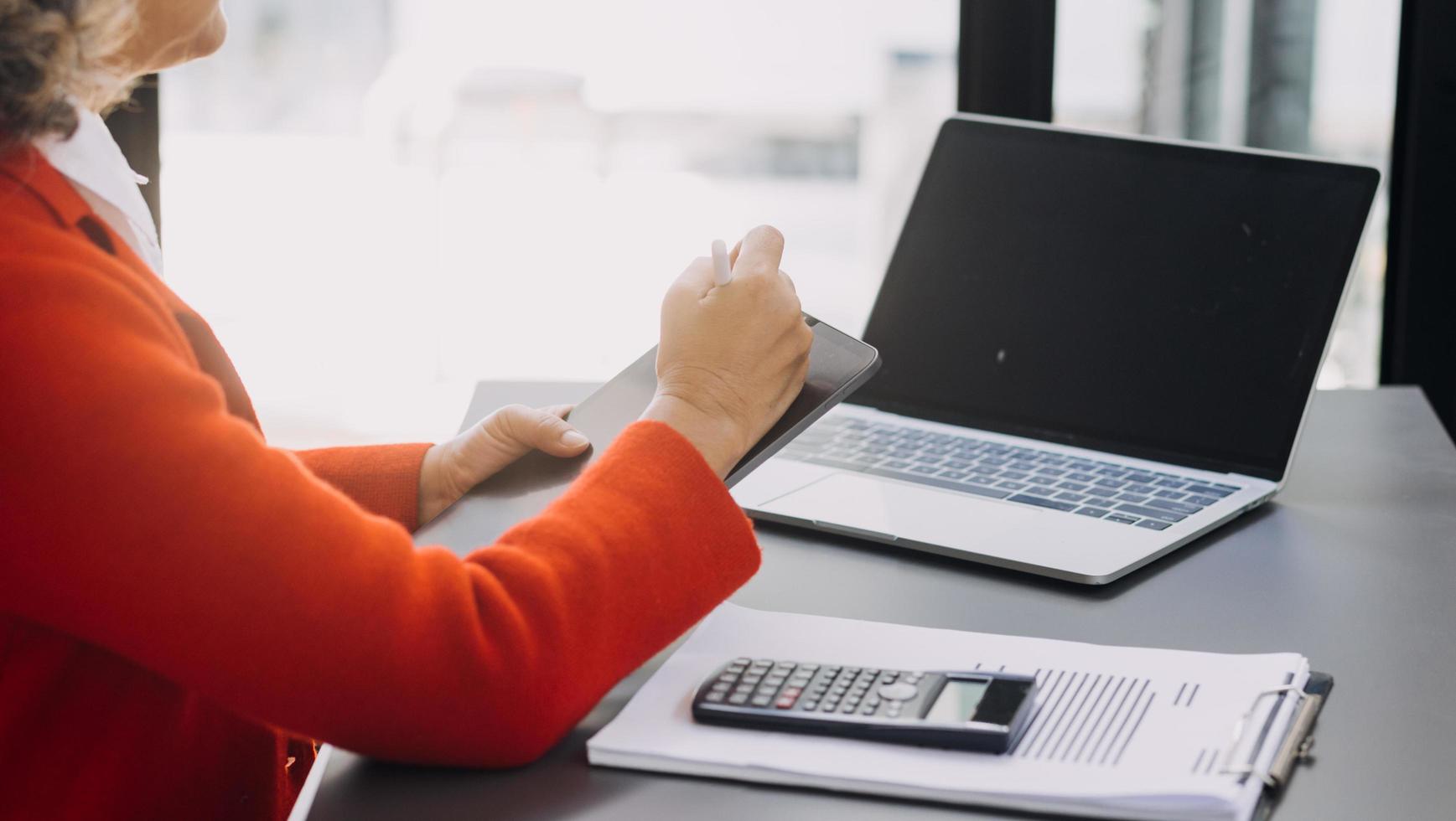 businesswoman hand working with laptop computer, tablet and smart phone in modern office with virtual icon diagram at modernoffice in morning light photo
