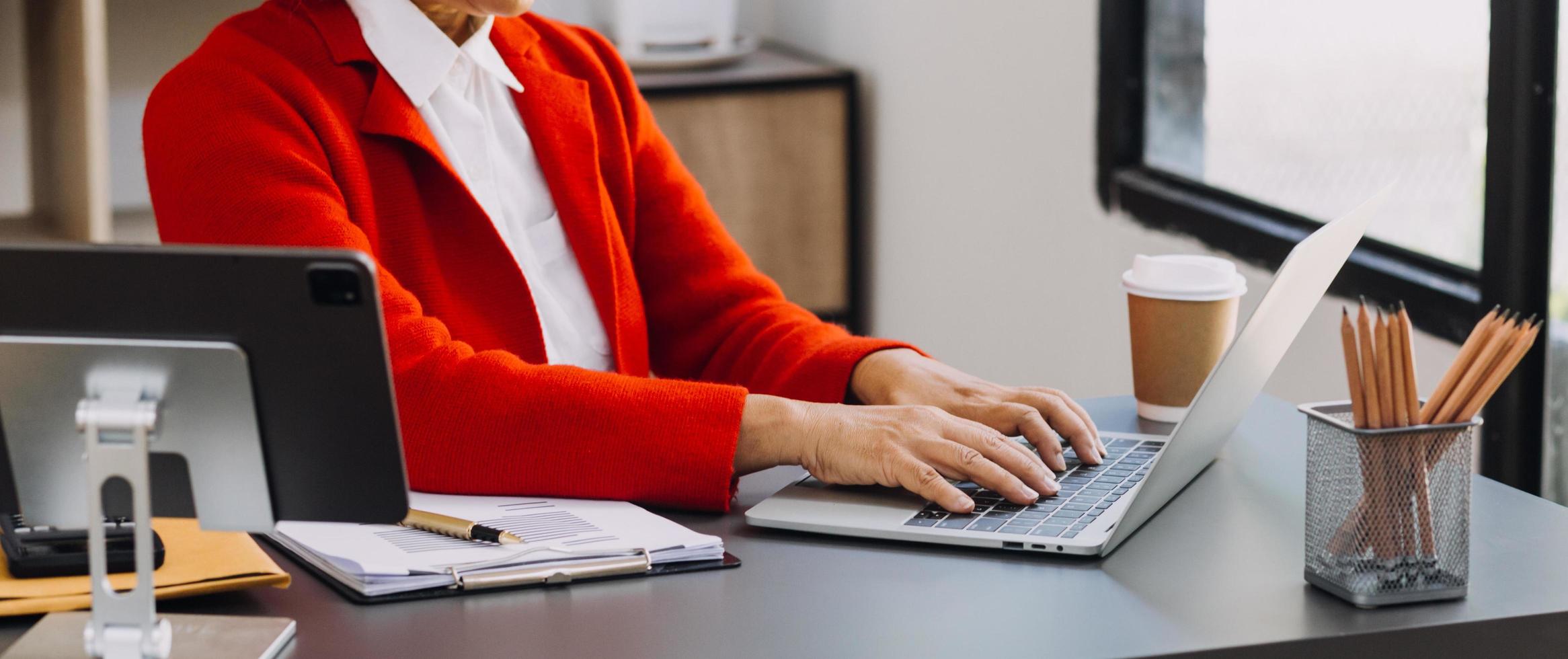 businesswoman hand working with laptop computer, tablet and smart phone in modern office with virtual icon diagram at modernoffice in morning light photo