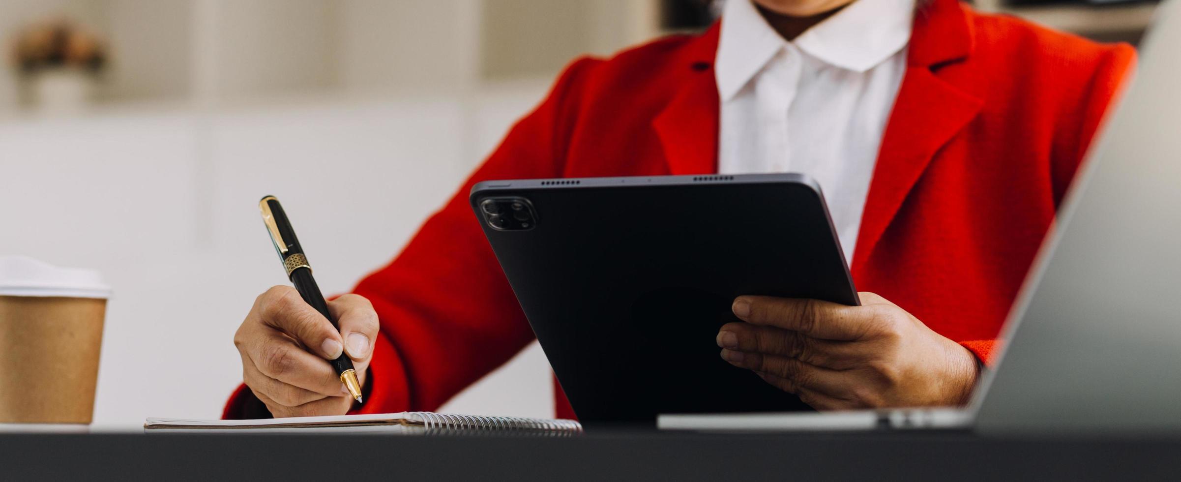 businesswoman hand working with laptop computer, tablet and smart phone in modern office with virtual icon diagram at modernoffice in morning light photo