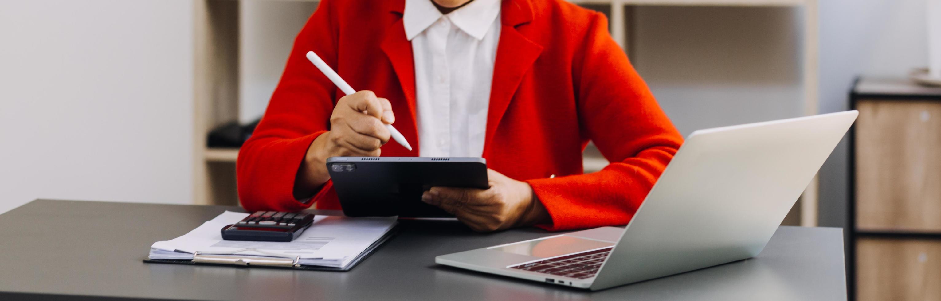 Businessman and team analyzing financial statement Finance task. with smart phone and laptop and tablet. Wealth management concept photo