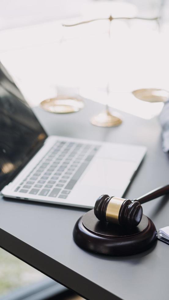 Male lawyer working with contract papers and wooden gavel on tabel in courtroom. justice and law ,attorney, court judge, concept. photo