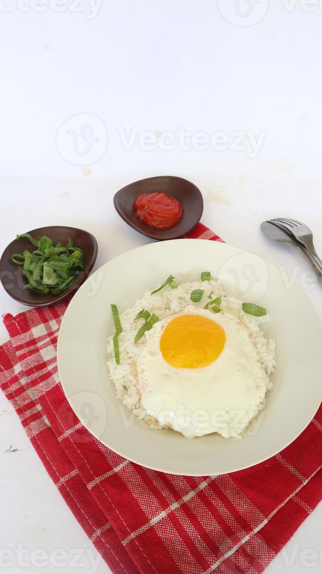 fried egg rice. breakfast fried egg sunny side rice on a plate, isolated on white background