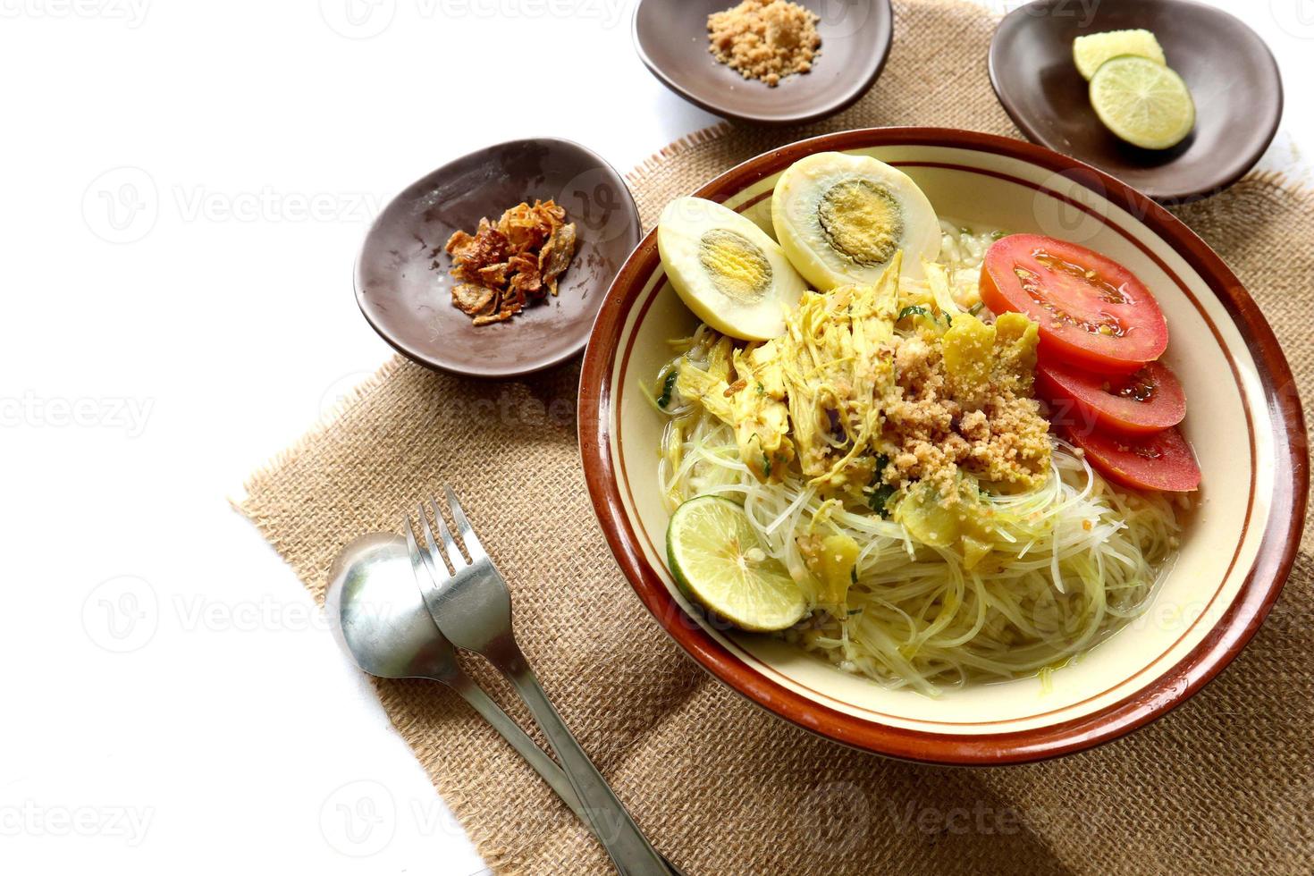 Soto Lamongan is a dish of Soup Lamongan, East Java, Indonesia. made of chicken, vermicelli, egg, bean sprout, turmeric, the broth and koya photo