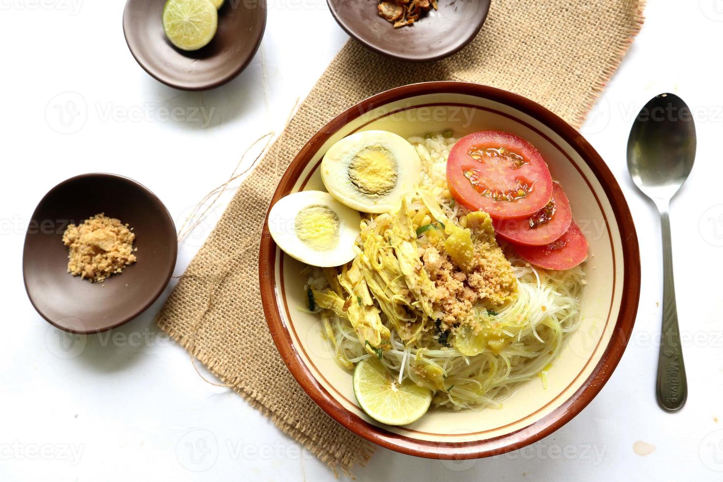 Soto Lamongan is a dish of Soup Lamongan, East Java, Indonesia. made of chicken, vermicelli, egg, bean sprout, turmeric, the broth and koya photo