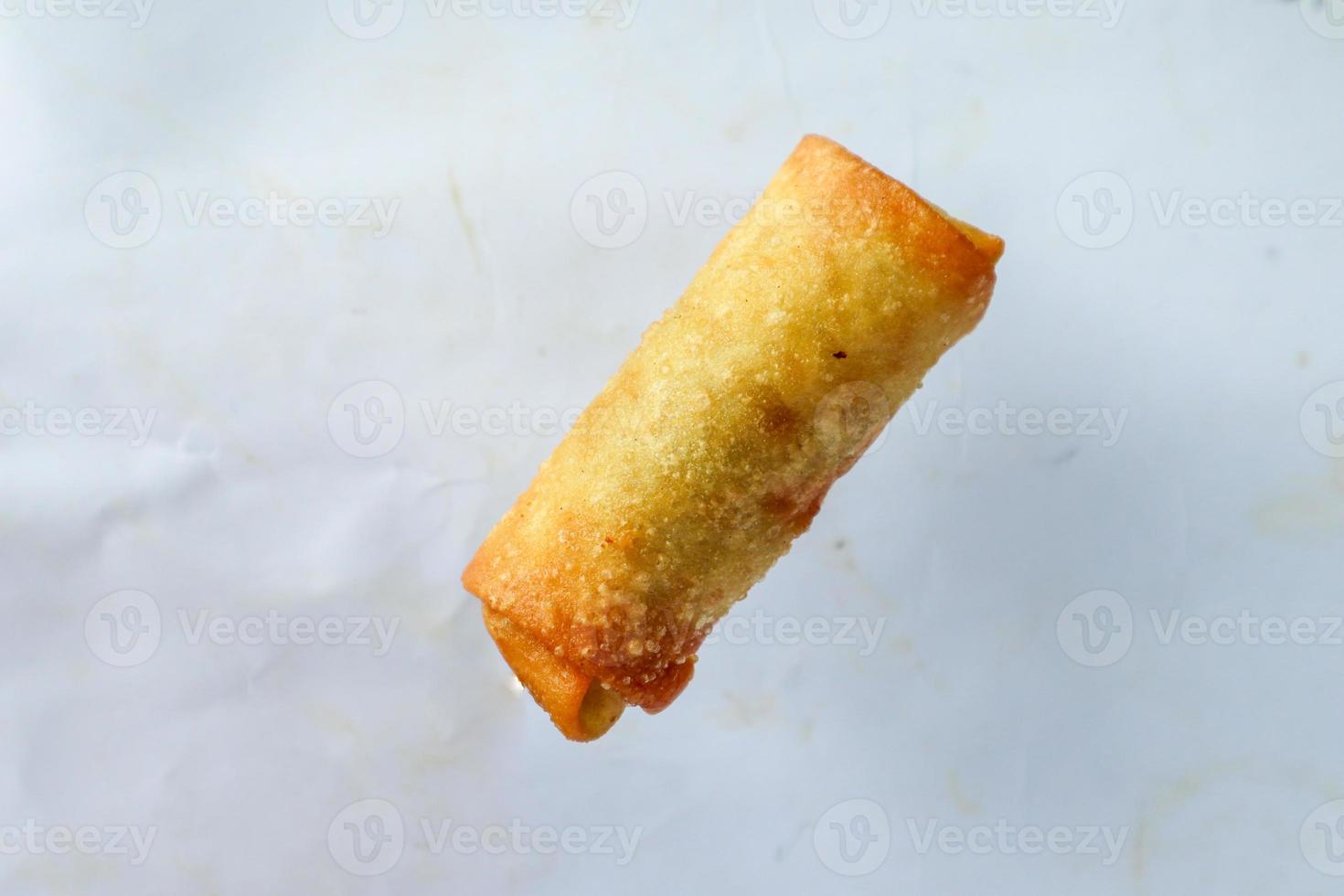 Lumpia or lunpia, is traditional spring roll skin snack from Semarang, Indonesia. Traditional Spring rolls made eggs, and chicken or shrimp, stir-fried bamboo shoots. isolated on white background photo