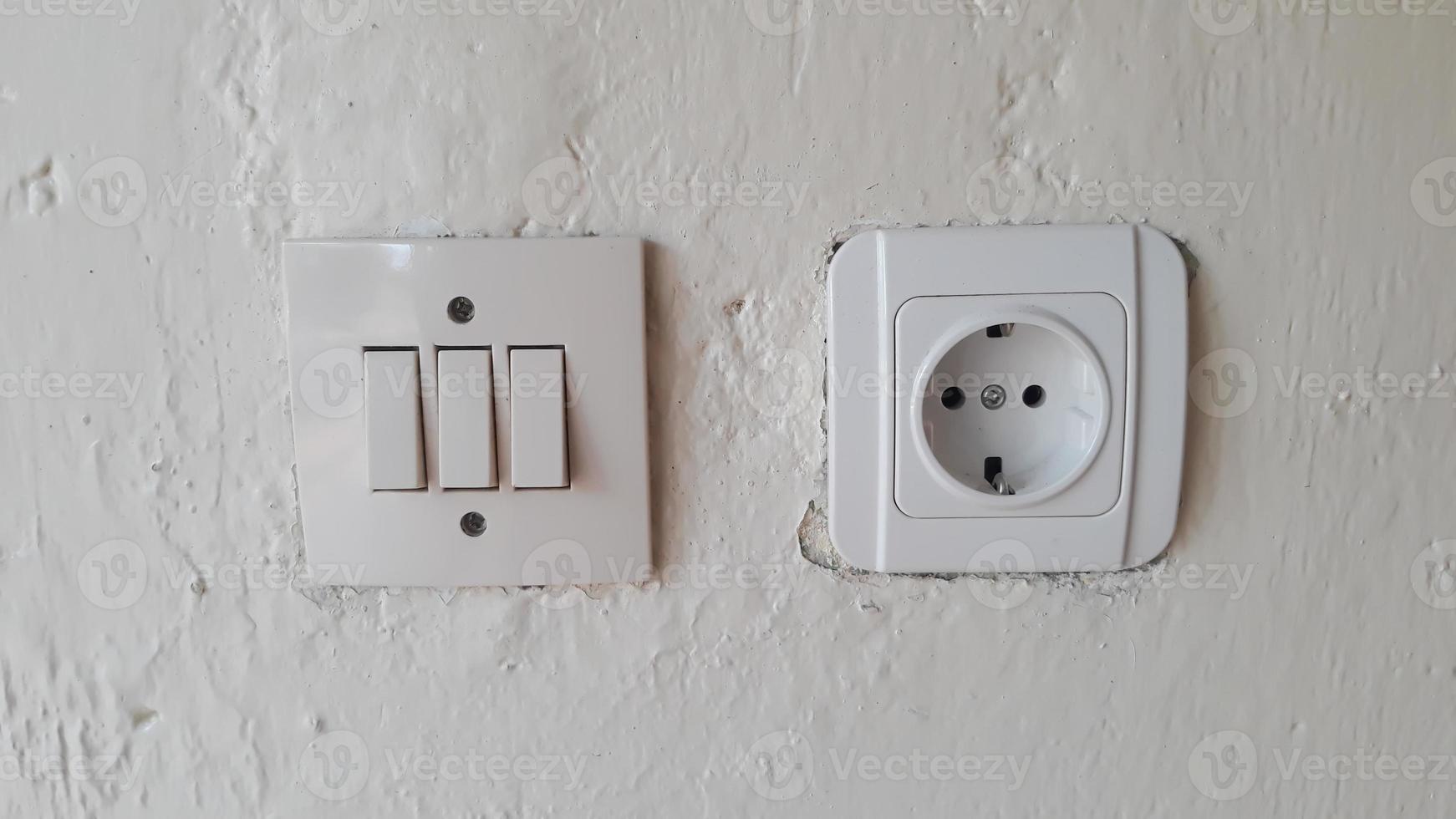 Switch and Electric socket and white wall Switch and Electric socket and white wall photo