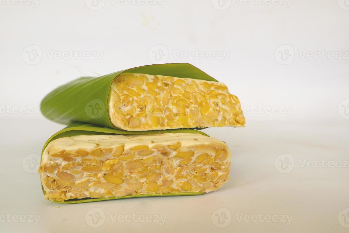 Raw tempeh or tempe. tempeh slices in white background. raw soybean seeds. Tempe is a traditional Indonesian food made from fermented soybeans. photo