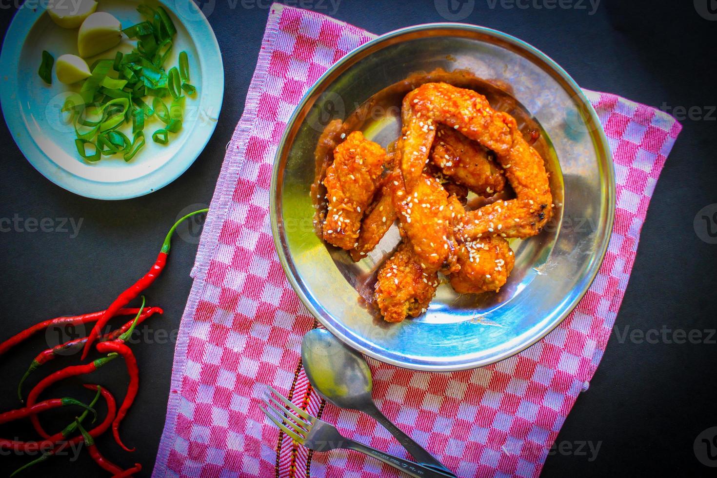Delicious homemade crispy fried chicken with spicy taste and lemon on plate photo
