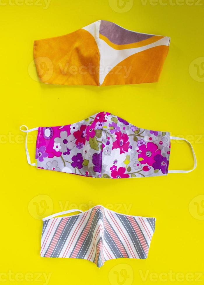 cloth mask or fabric face mask with cotton fabric flower pattern handmade crafts isolated on white background. This hygienic mask for cover mouth and protection with beautiful sewing fashion. photo