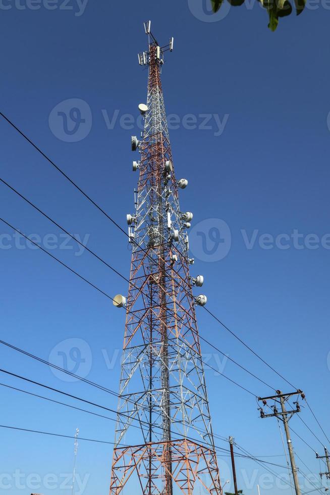 communication tower. Telco Trellis for 3G 4G 5G Apocalypse Internet Communication, mobile, FM Radio and Television Broadcasting On Air with Blue Sky in Background photo