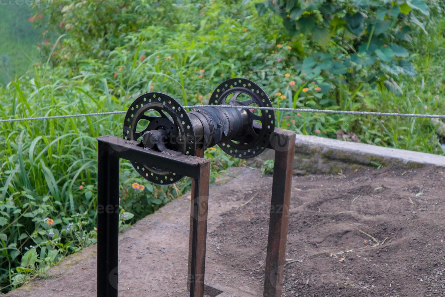 Pulleys are simple machines consisting of a wheel over which a pulled rope runs to change the direction of the pull used for lifting a load photo