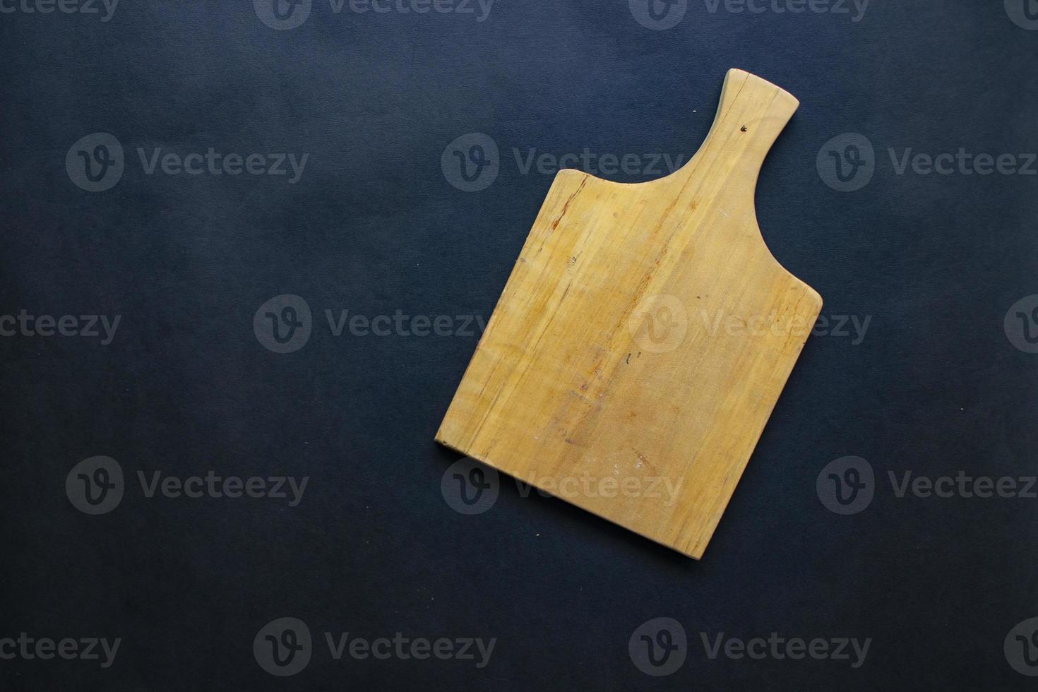 Cutting board from wood for cooking. wooden cutting board on black background. Top view with copy space for text. Menu, recipe, flat lay mockup, banner background photo