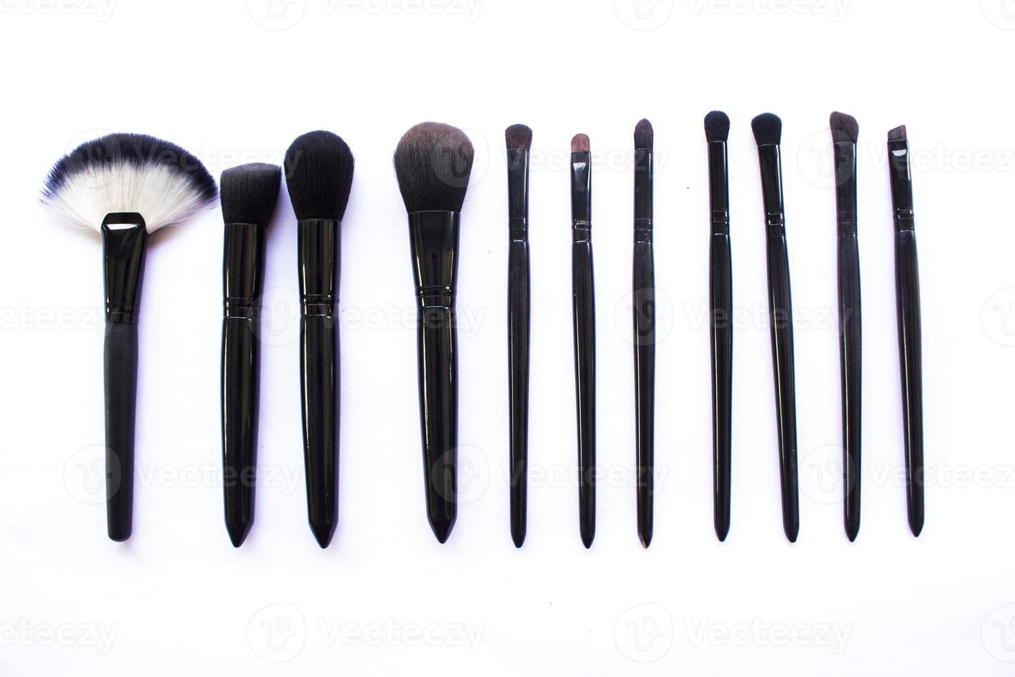 makeup brushes set isolated on white background. Top view, flat lay photo