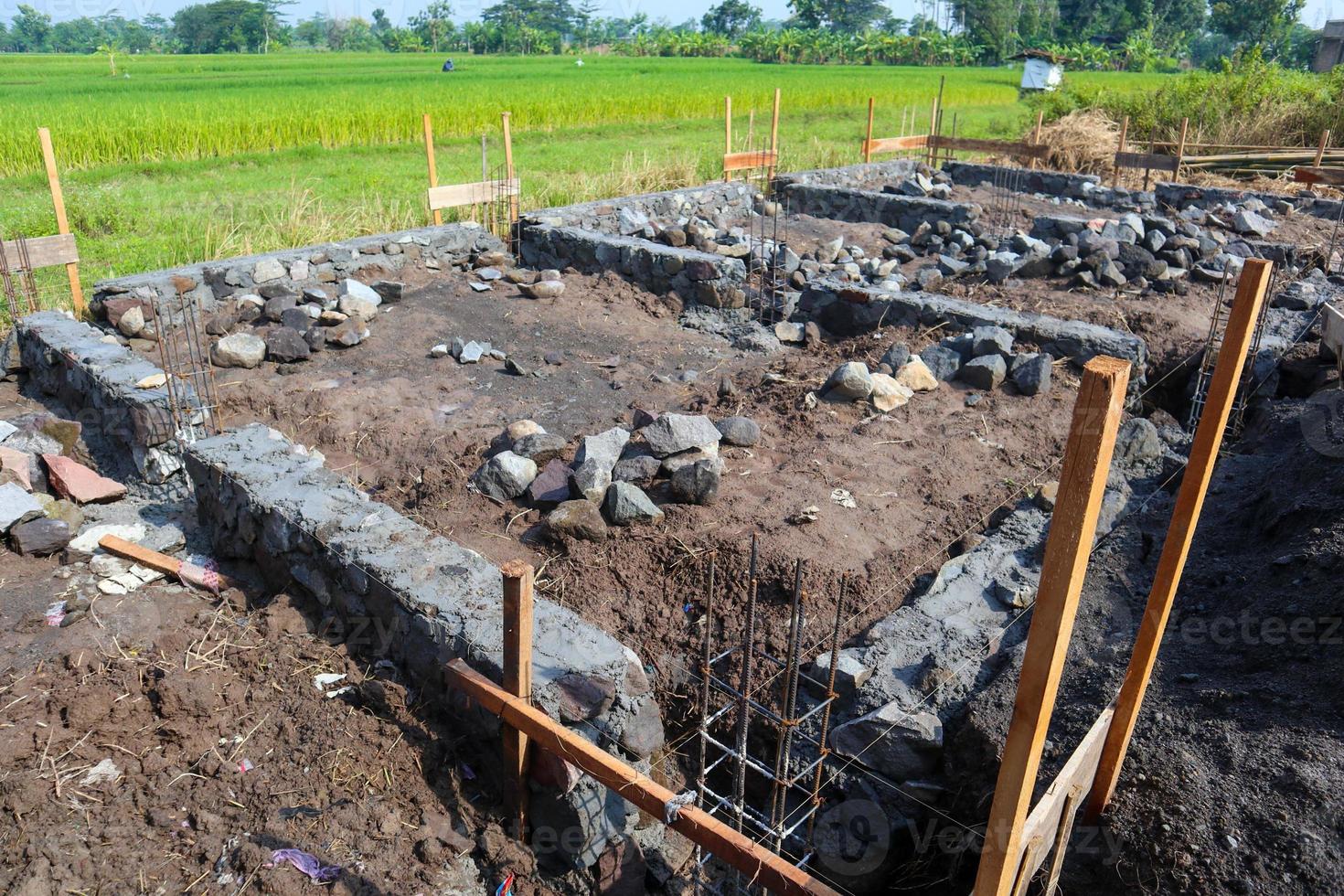 The foundation for the house. Laying the foundation made from stone, sand, semen and steel. Construction works. photo