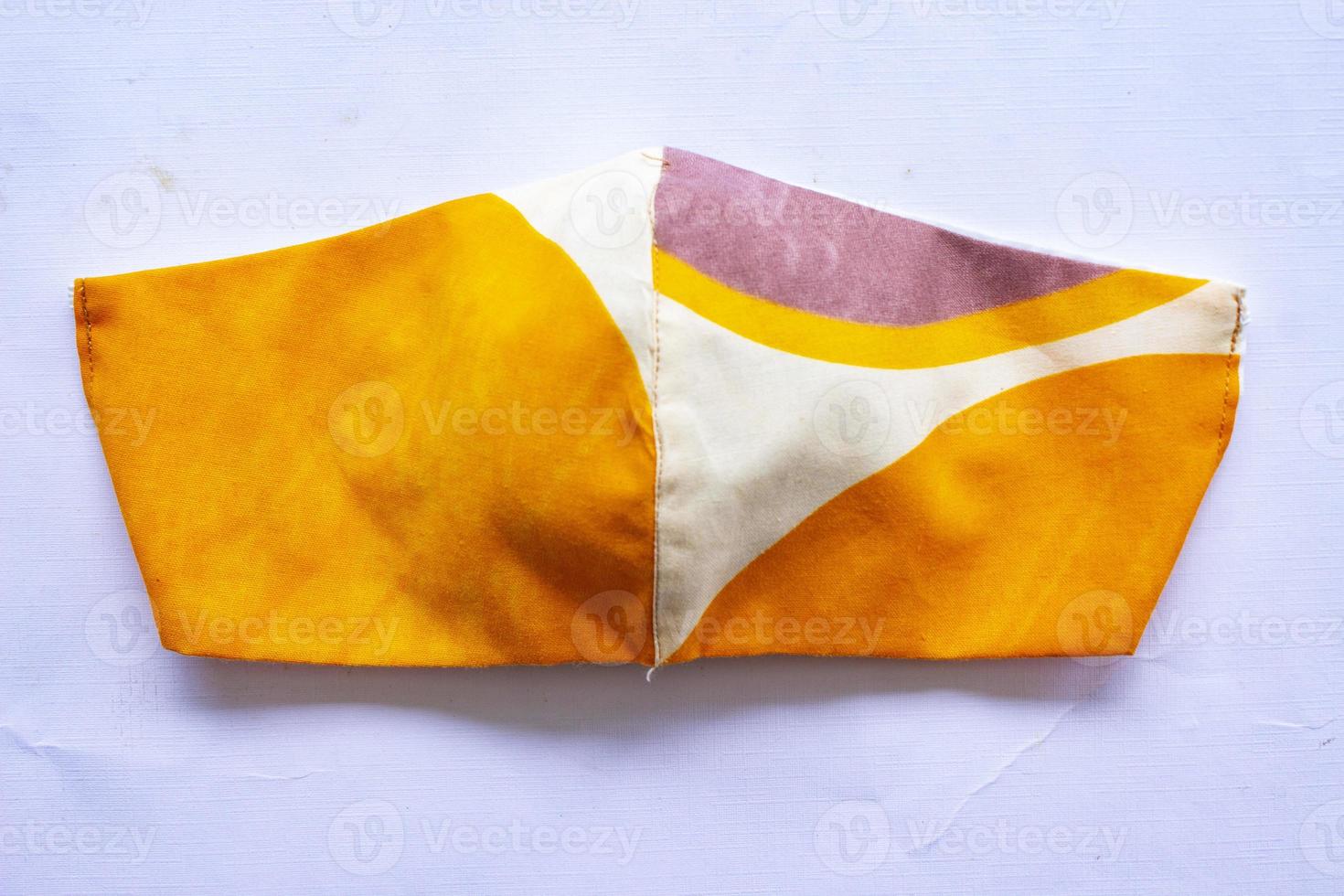 cloth mask or fabric face mask with cotton fabric flower pattern handmade crafts isolated on white background. This hygienic mask for cover mouth and protection with beautiful sewing fashion. photo